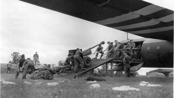 Soldiers dragging a canon in a Horsa aircraft in preparation for D-Day